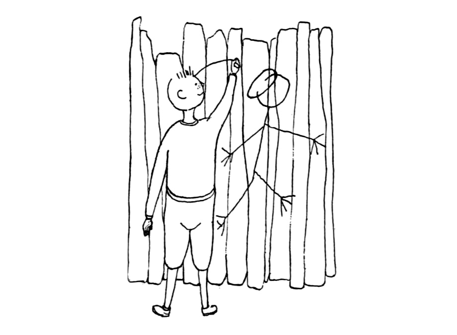 Мальчик рисует на заборе